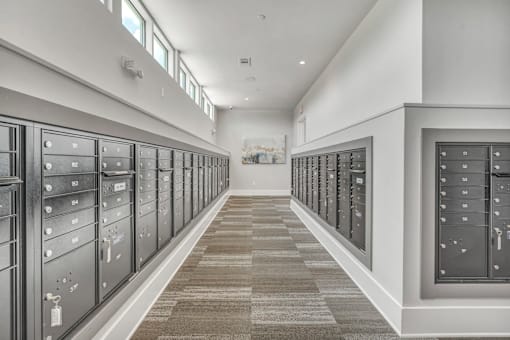 A long hallway with a carpeted floor and a series of lockers on both sides.
