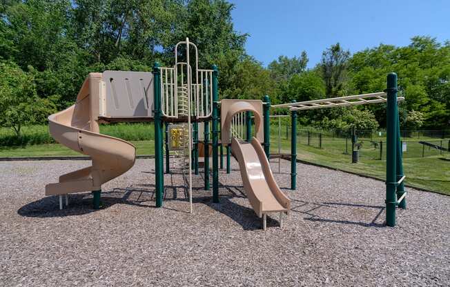 a playground with two slides and a swing set