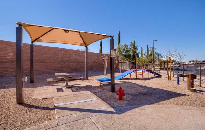 a playground with a fire hydrant and picnic tables