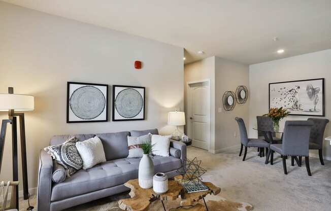 a living room and dining room with a couch and a table  at Aventura at Hawk Ridge, Lake St Louis, MO