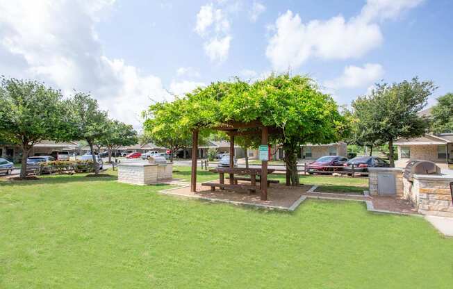 A park with a gazebo and a bench.