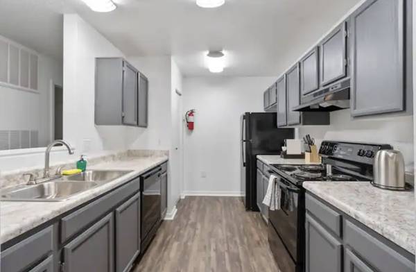 a kitchen with stainless steel appliances and marble counter tops