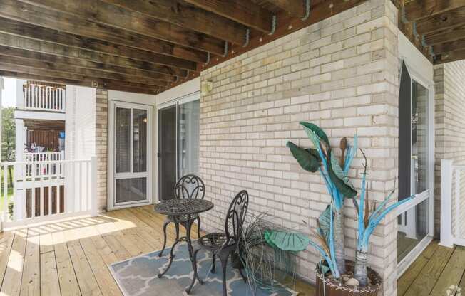 a patio with a table and chairs