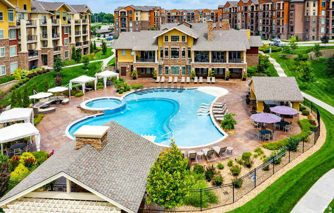 A large house with a pool in the middle of it.