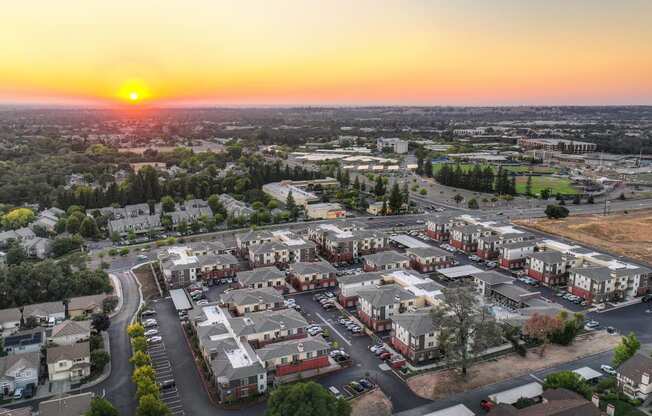 an aerial view of Sierra Gateway Apartments at sunset with Sierra College in the distance
