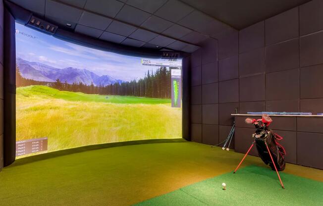a golf simulator in a room with a view of a golf course