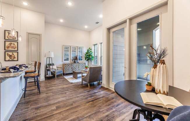 A modern kitchen with a dining table and chairs.