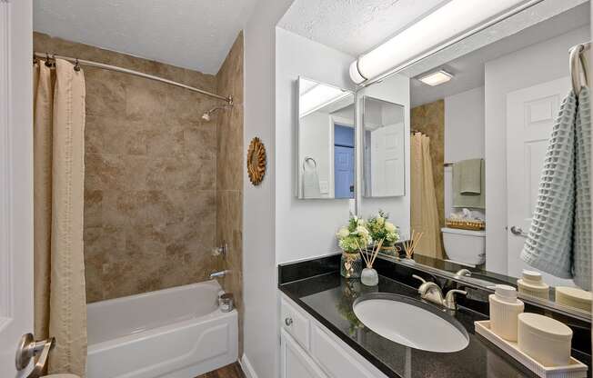 a bathroom with a shower and a sink and a mirror