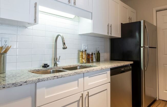 Webb Bridge Crossing Apartments in Alpharetta Georgia photo of kitchen with white cabinets and stainless steel appliances