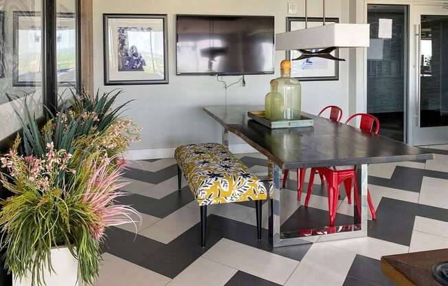 a dining room with a table and chairs and a checkered floor