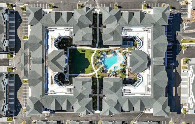 A top-down view of a complex with a pool in the center.