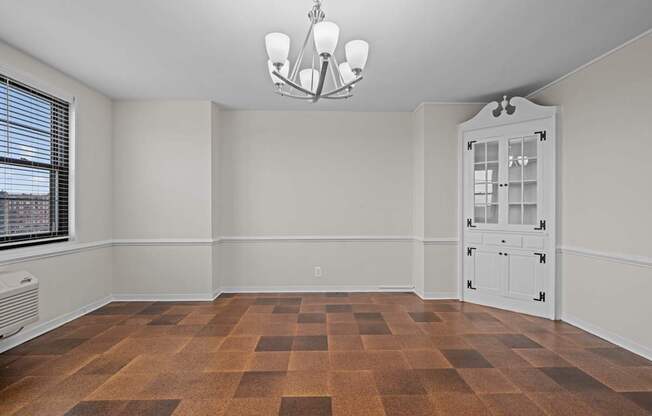 A room with a brown checkered floor and a white door.