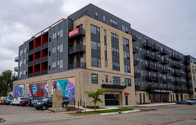 a large apartment building with graffiti on the side of it