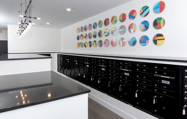 a wall of wine cabinets in a white room with a black counter top