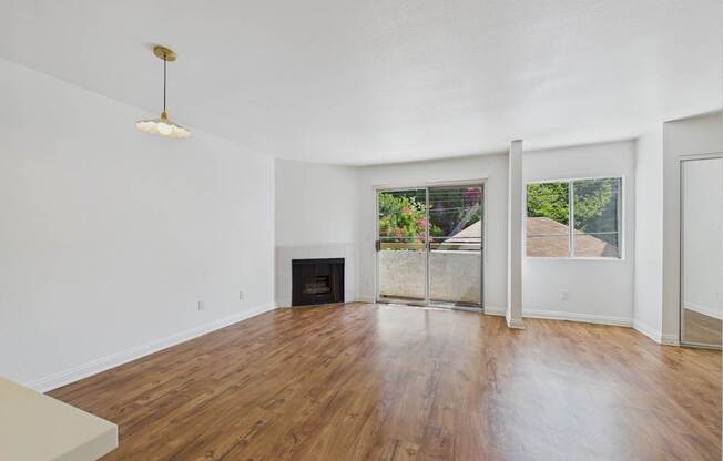 A room with a fireplace and sliding glass doors.
