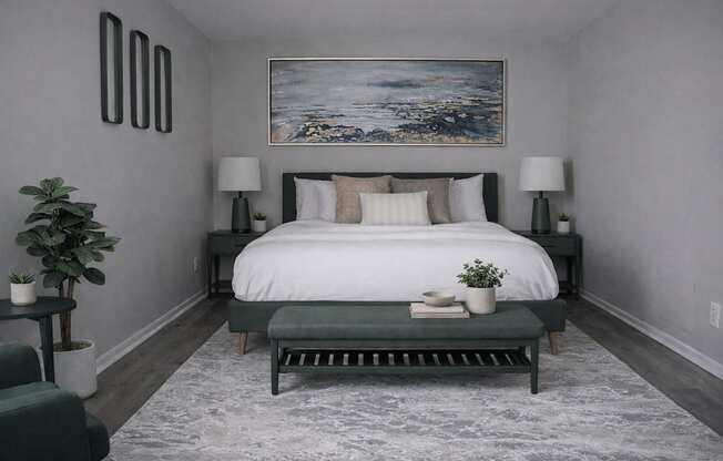 A bedroom with a large bed and a painting on the wall.