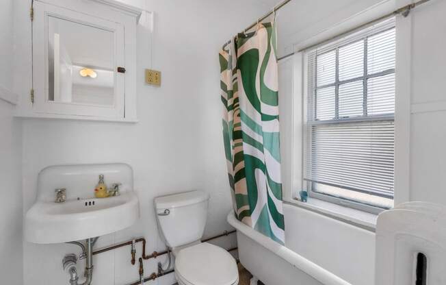 a bathroom with a sink toilet and bathtub