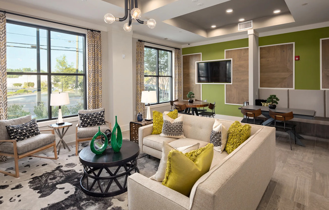 Resident lounge at our Atlanta apartments for rent, featuring cushioned chairs and a flat screen TV.