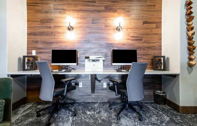 a conference room with two computer desks and chairs at The links at Plum Creek Apartments, Colorado, 80104