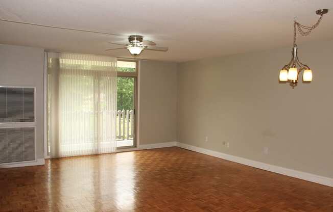 an empty living room with wood floors and a ceiling fan at Renew Worcester, Worcester, MA, 01602