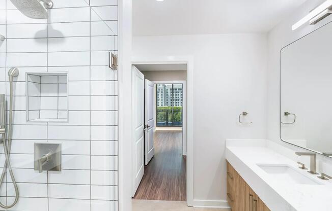 Elevate your everyday routine at Modera Parkside with designer bathrooms featuring double vanities and luxurious quartz countertops. Enjoy the spa-like experience of frameless glass showers surrounded by stunning floor-to-ceiling tile, all in the heart of Midtown Atlanta!