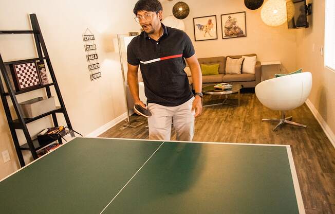 man playing ping pong at the clubhouse