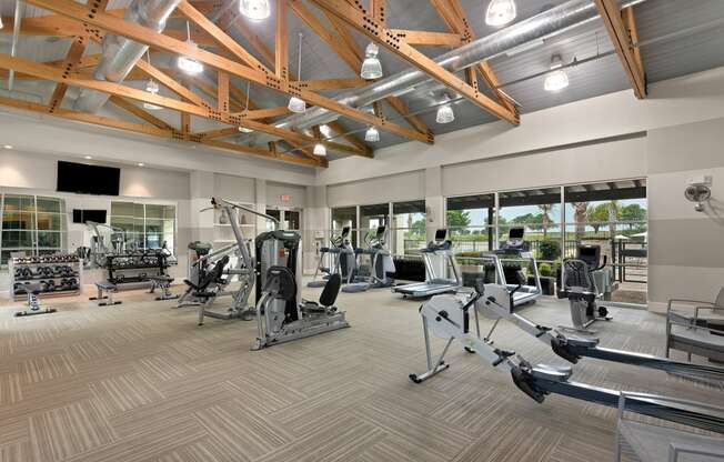 a spacious fitness center with treadmills and other exercise equipment