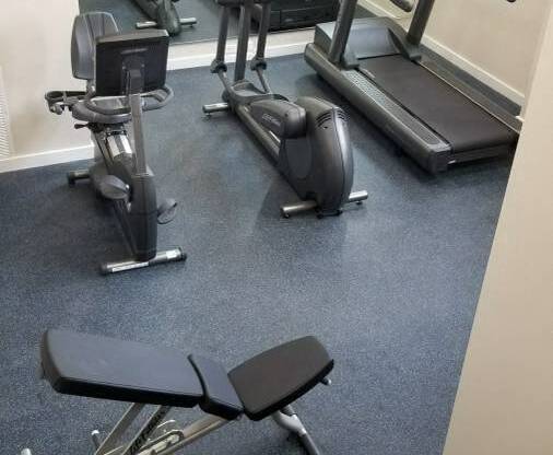 a room filled with lots of different types of exercise equipment
