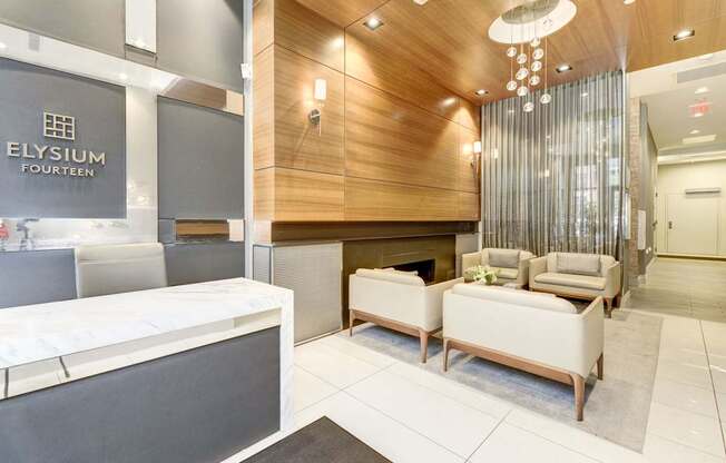 A reception area with a white reception desk and a sign that says Elysium Fourteen.
