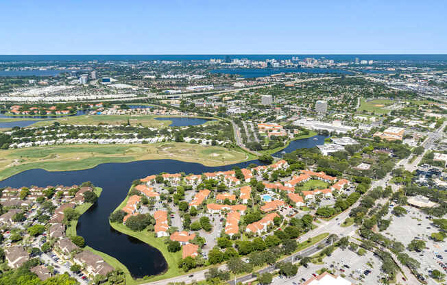 A bird's eye view of a residential area with a river running through it.