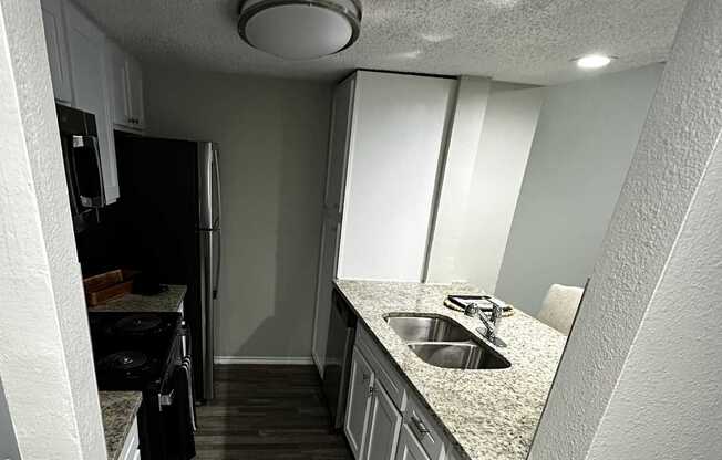 A white cabinet with a vent on top is in a room with wood paneling.