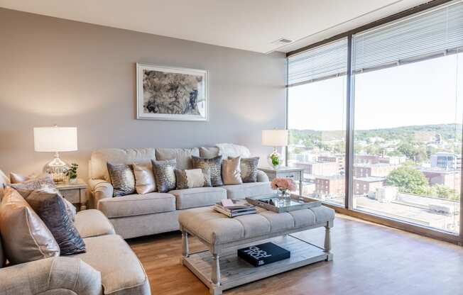 a living room with a large window and a view of the city