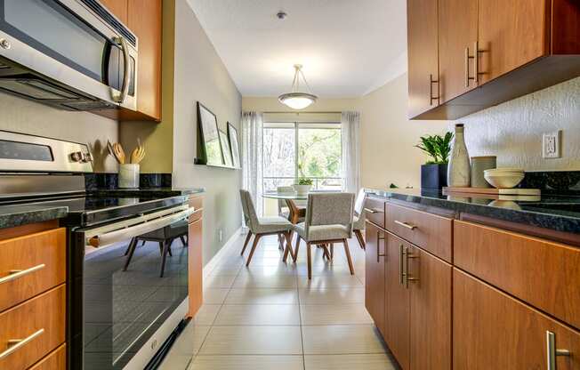 Kitchen with stainless steel appliances and dining area