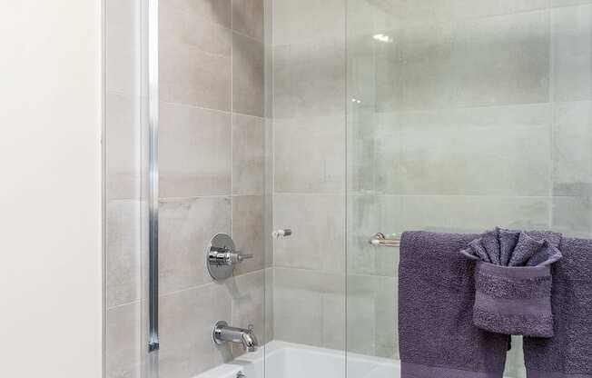 a shower with a glass door in a bathroom