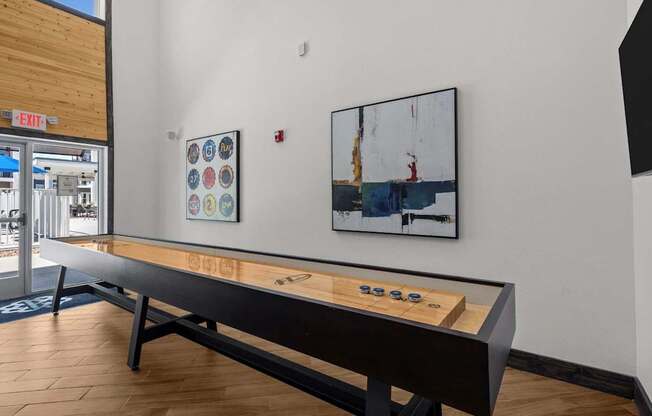 A shiny wooden table with a few coins on it.
