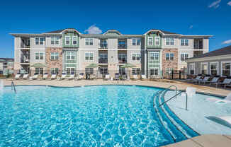 a swimming pool with an apartment building in the background