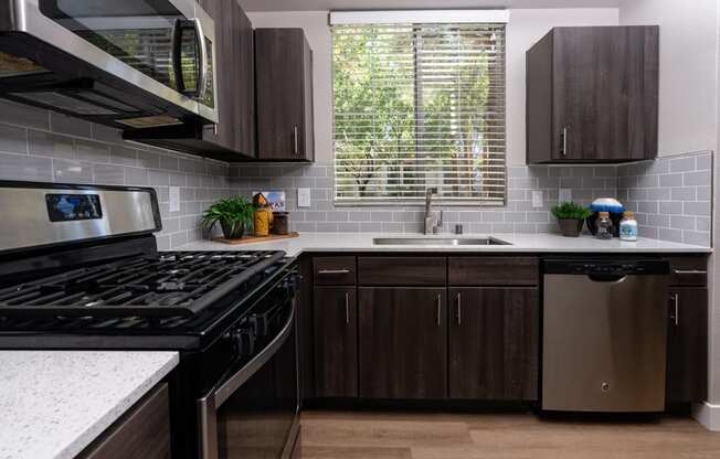 a kitchen with stainless steel appliances and wooden cabinets