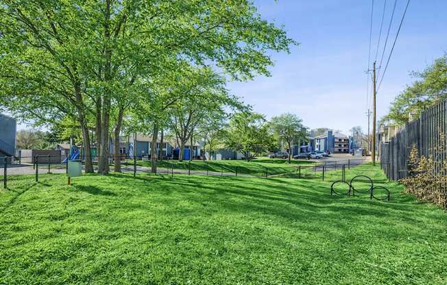 A park with a green lawn and trees.