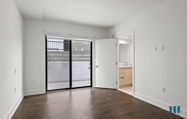 Bedroom with Vinyl Flooring, Bathroom, and Patio