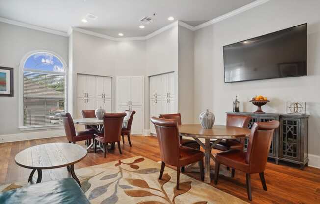 a living room with a table and chairs and a television