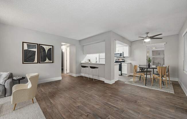 Model Dining Room and Kitchen Area with Wood-Style Flooring at Crystal Creek Apartments located in Phoenix, AZ.