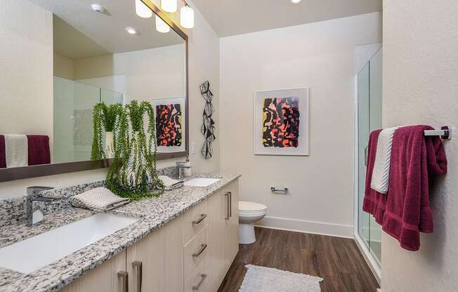 Bathroom with double vanity in select homes at The Exchange Luxury Apartments in St. Petersburg, FL