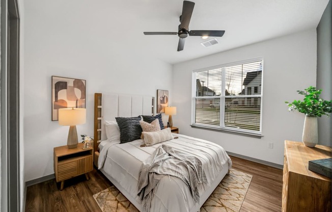 a bedroom with a large bed and a ceiling fan at The BLVD at Wilson Crossings, Michigan