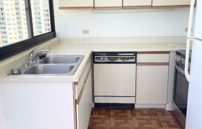 Rarely available corner end 2 bed 2 bath unit with 2 assigned parking stalls on high floor