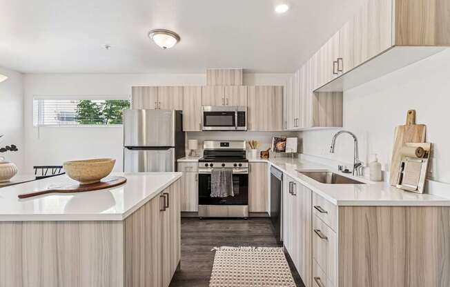 A modern kitchen with wooden cabinets and stainless steel appliances.