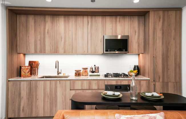 a kitchen with wooden cabinets and a black table