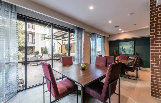 A dining room with a table and chairs.
