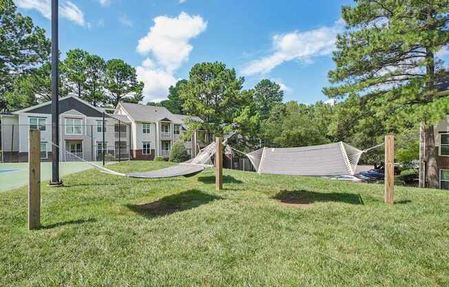 A residential area with houses and a hammock at The Falls Apartments in Raleigh NC