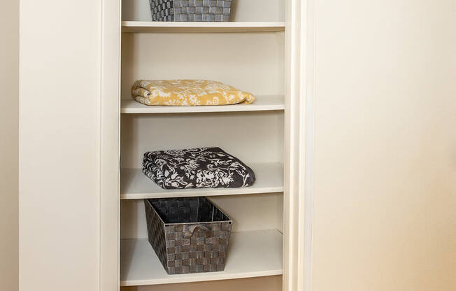 a built in shelving unit with baskets and a vase in the corner of a room at Chapel Valley Townhomes, Baltimore Maryland
