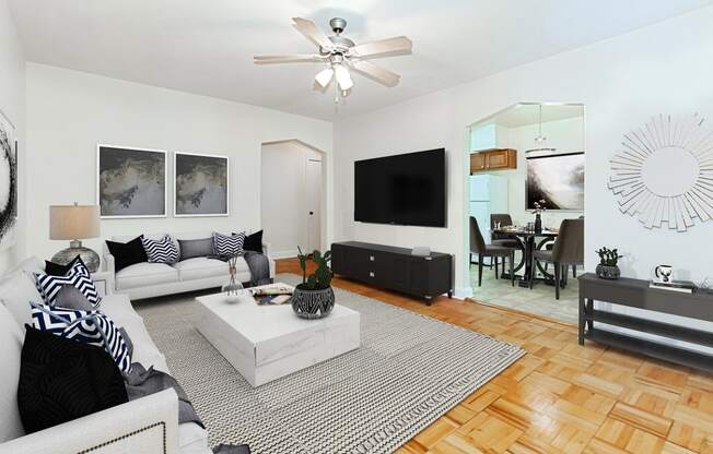living area with sofa, love seat, hardwood floors and view of dining area at  1400 van buren apartments washington dc